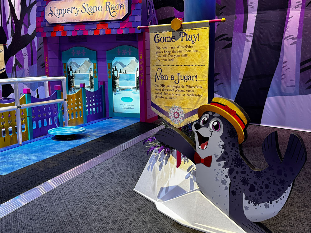 Flip the harbor seal in front of the Slippery Slope Race in the Games section of WinterFaire.